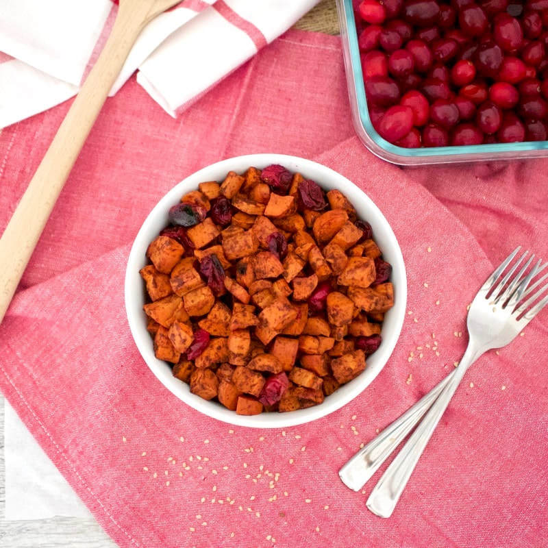 These Cinnamon Roasted Carrots and Cranberries are a great, colorful side dish that is sure to be loved by the whole family. This recipe is vegan, gluten-free, paleo, oil-free, and contains no added sugar. The perfect vegan Thanksgiving recipe.